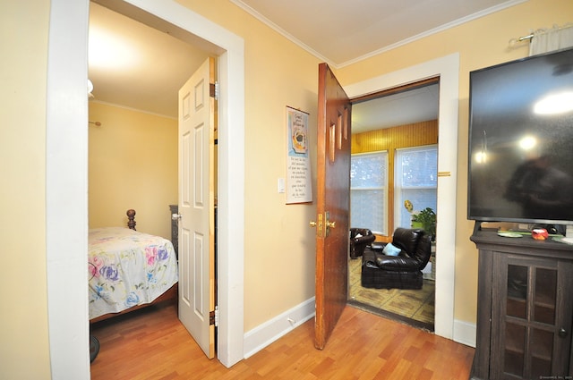 corridor featuring light hardwood / wood-style floors and crown molding