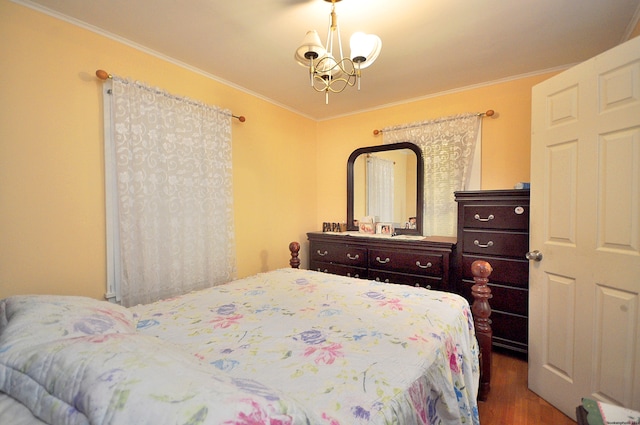 bedroom featuring dark hardwood / wood-style flooring, a chandelier, and ornamental molding