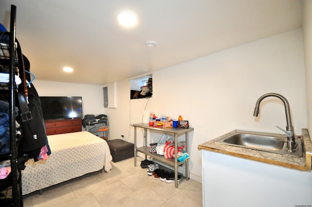 bedroom with sink and light tile patterned flooring