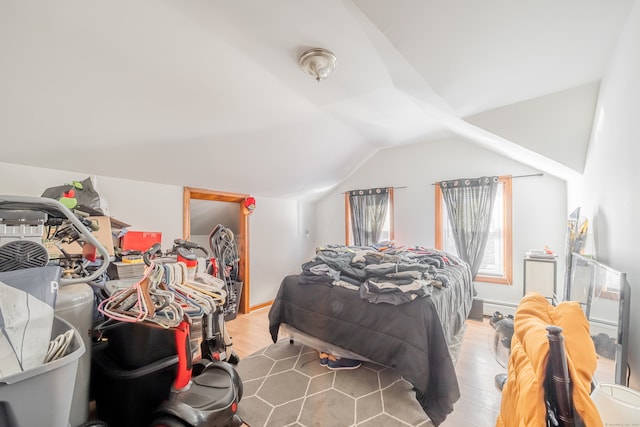 bedroom with hardwood / wood-style floors and vaulted ceiling