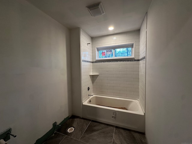 bathroom with tile patterned flooring and tiled shower / bath