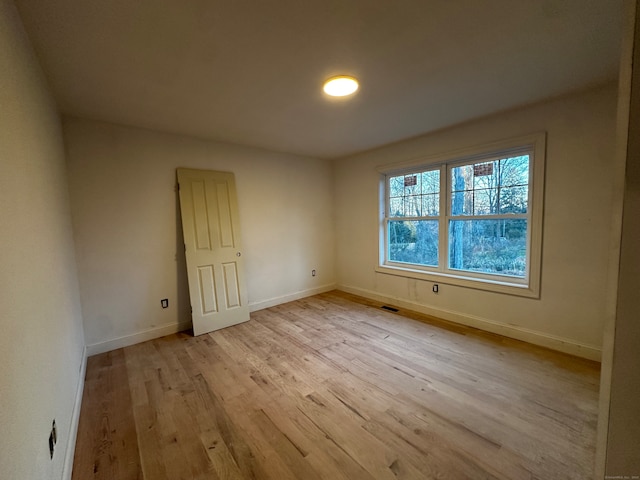 spare room with light hardwood / wood-style floors