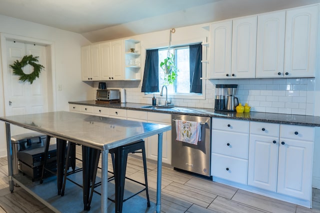 kitchen with white cabinets, dishwasher, sink, and tasteful backsplash