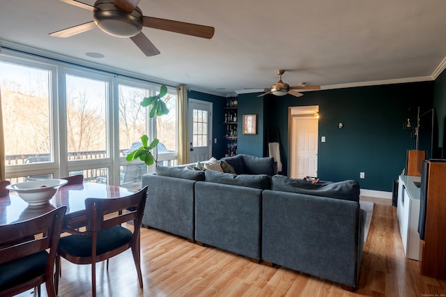 living room with light wood-type flooring, ceiling fan, and ornamental molding