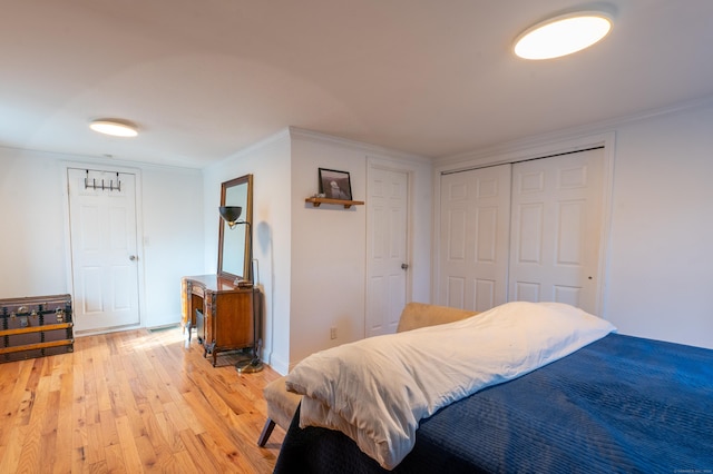 bedroom featuring light hardwood / wood-style floors and ornamental molding