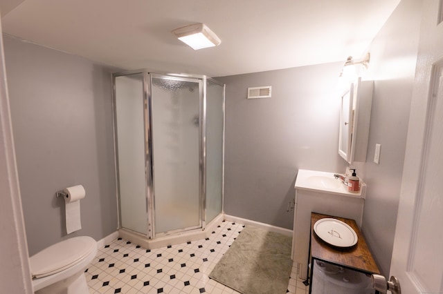 bathroom featuring vanity, toilet, and walk in shower