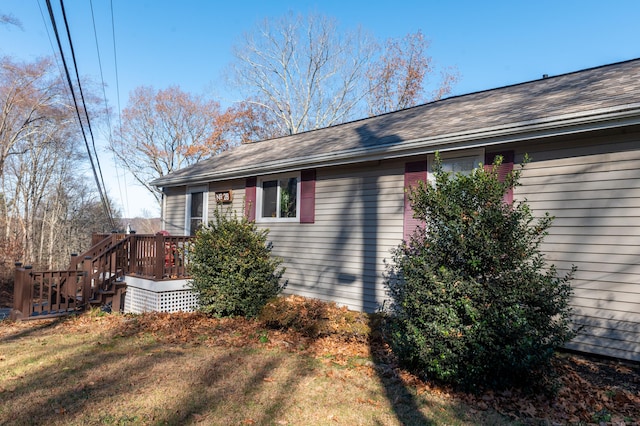 view of home's exterior with a lawn and a deck