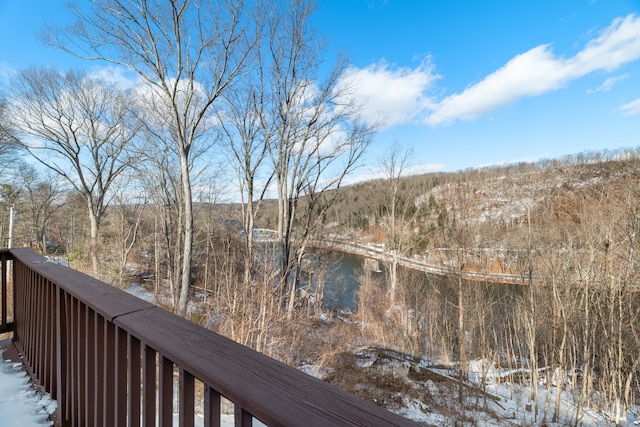 snow covered deck with a water view