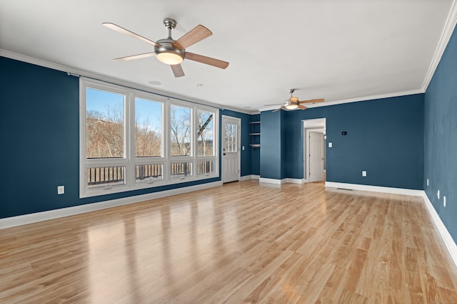 spare room with light wood-type flooring, plenty of natural light, crown molding, and ceiling fan