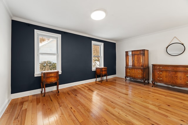 sitting room featuring ornamental molding, light hardwood / wood-style flooring, and a healthy amount of sunlight