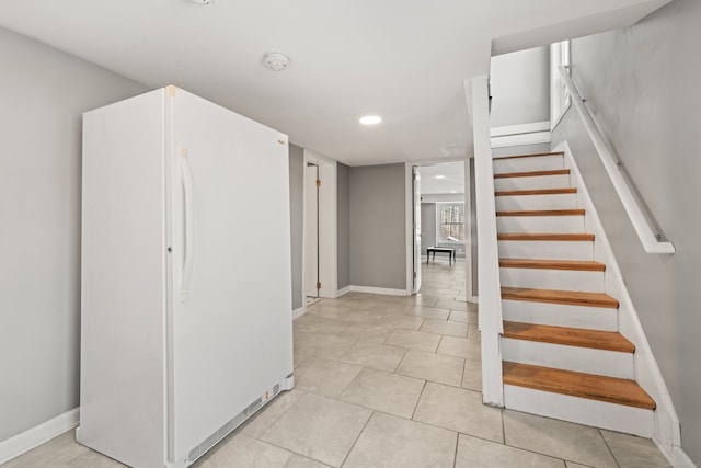 staircase featuring tile patterned floors