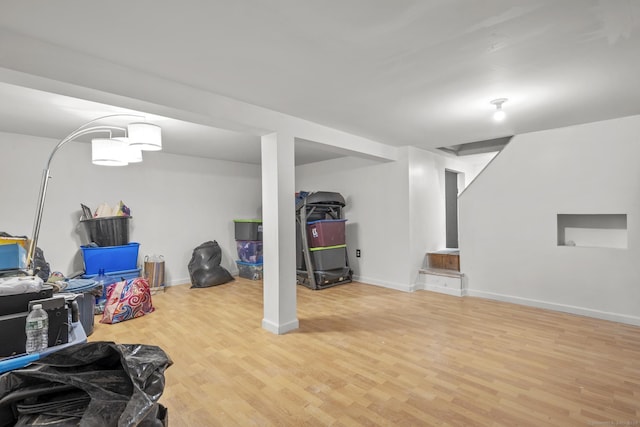 basement with hardwood / wood-style floors