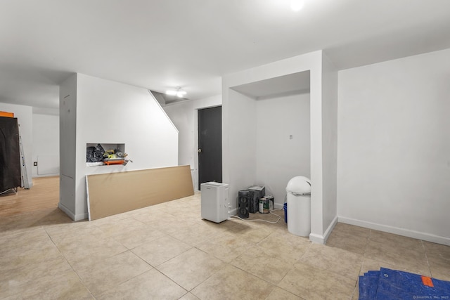 basement featuring light tile patterned flooring