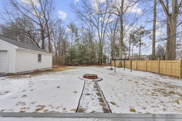 yard layered in snow featuring a fire pit