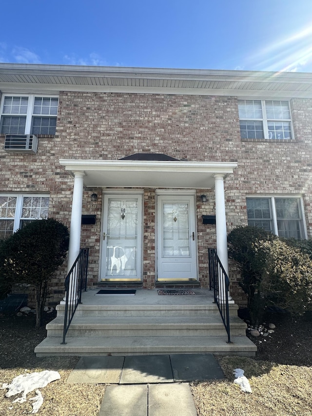 property entrance with brick siding