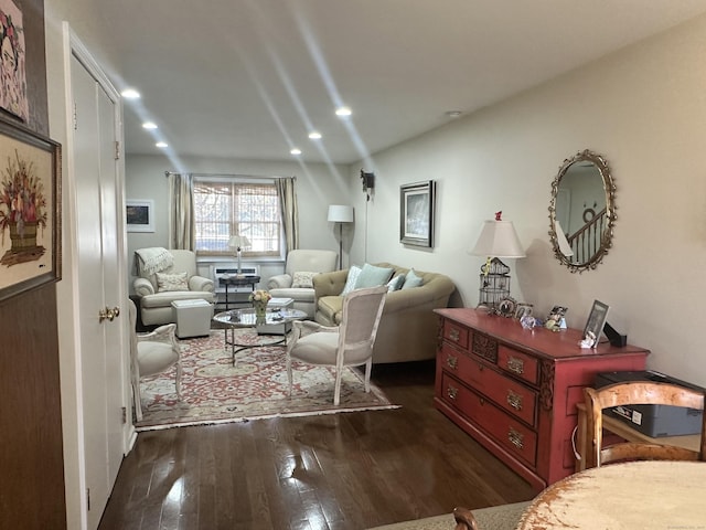 living room featuring dark wood-type flooring and recessed lighting