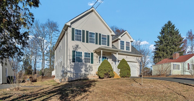 view of front of property with a garage and a front lawn