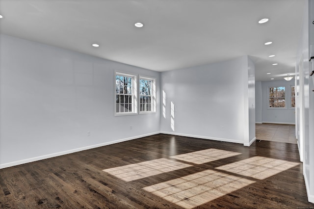 spare room featuring dark wood-type flooring