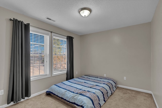 carpeted bedroom with a textured ceiling