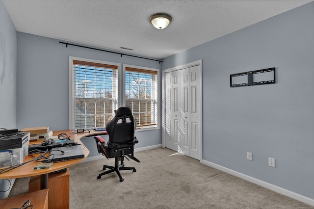 carpeted office with a textured ceiling