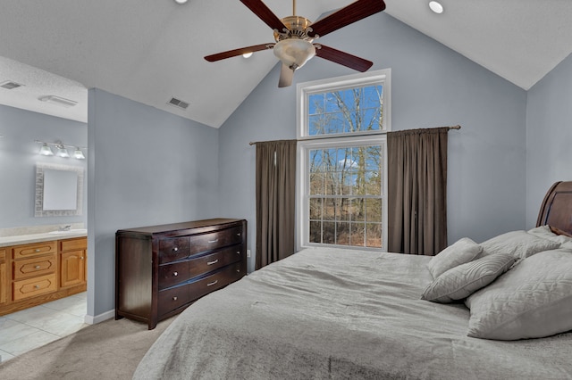 carpeted bedroom with connected bathroom, ceiling fan, sink, and high vaulted ceiling