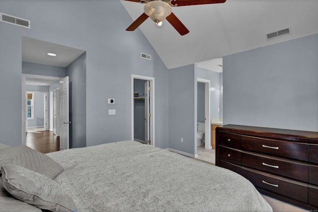 bedroom with high vaulted ceiling, ceiling fan, a spacious closet, connected bathroom, and light hardwood / wood-style floors