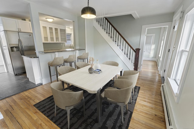 dining area featuring light hardwood / wood-style floors and baseboard heating