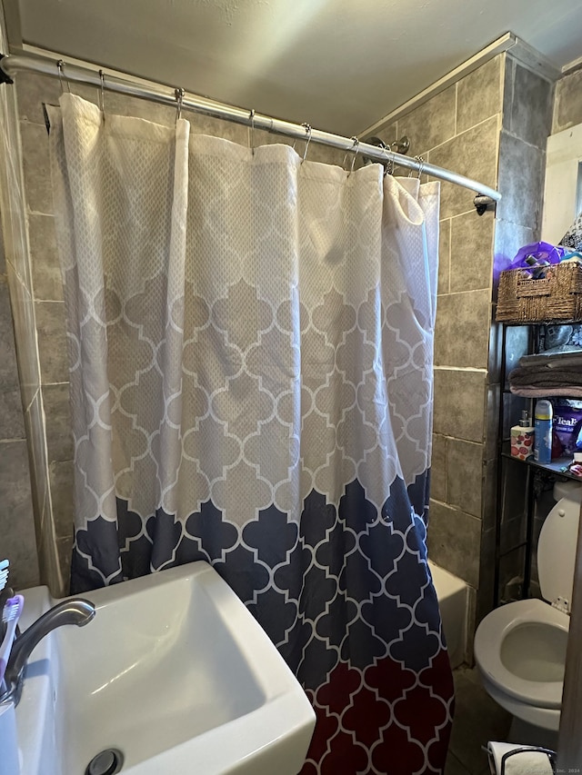 full bathroom with sink, shower / tub combo with curtain, and toilet