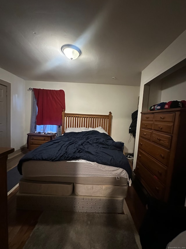 bedroom featuring dark hardwood / wood-style flooring