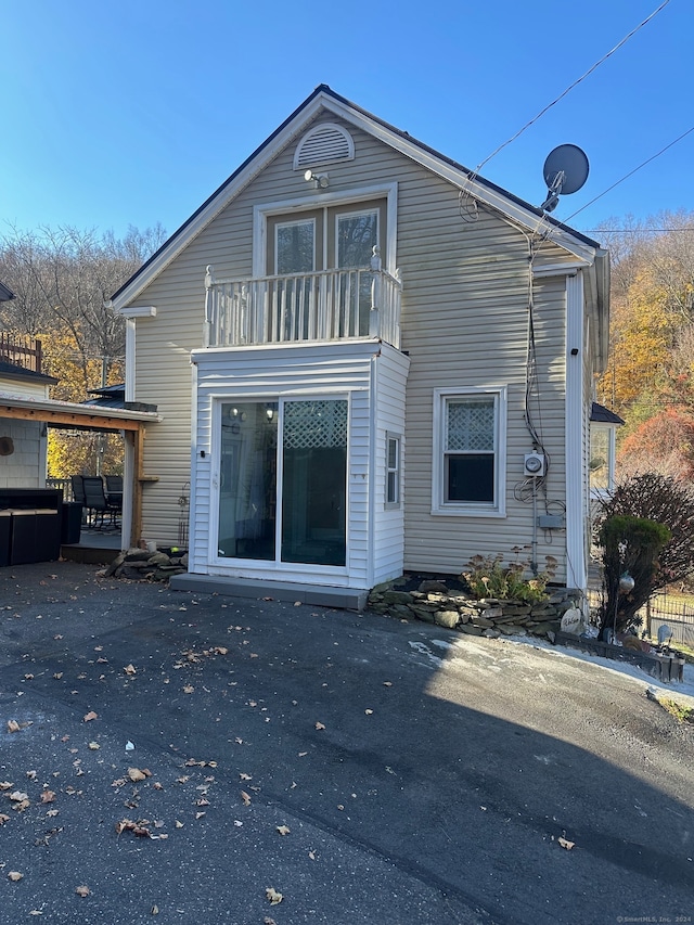 rear view of house featuring a balcony