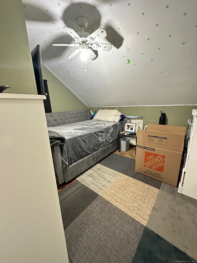 bedroom featuring ceiling fan, carpet floors, and lofted ceiling