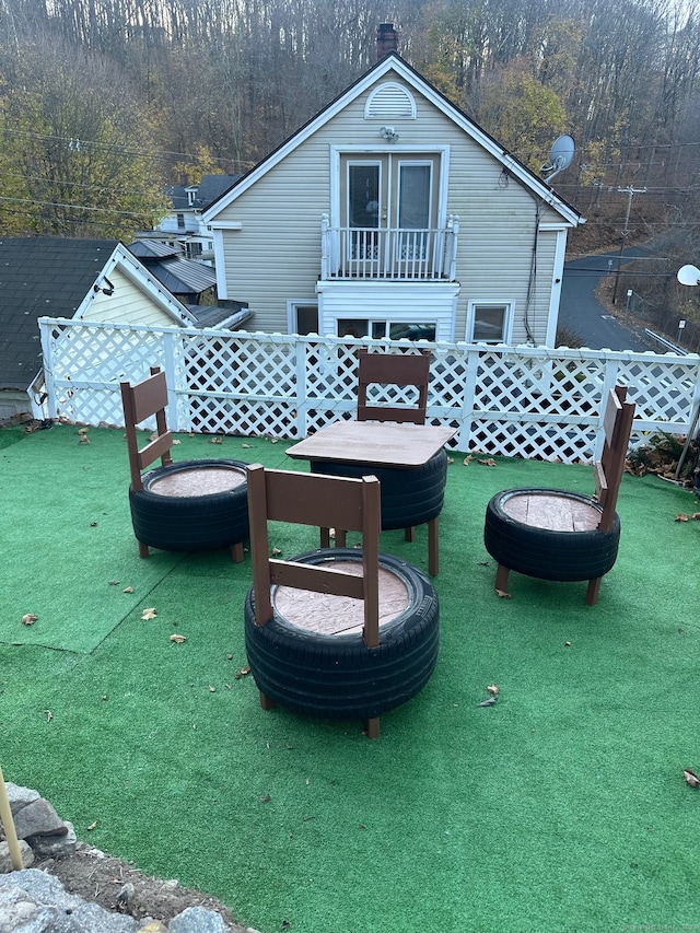 view of patio / terrace with a balcony and an outdoor fire pit