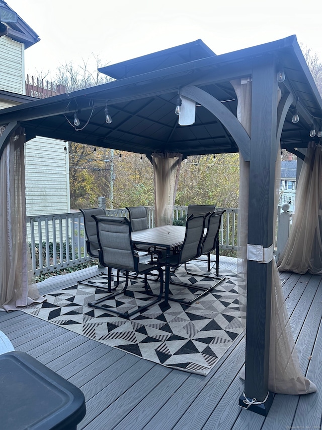 wooden terrace featuring a gazebo