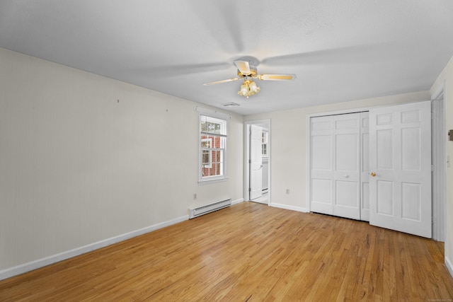 unfurnished bedroom with ceiling fan, light wood-type flooring, and a baseboard heating unit