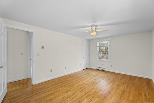 empty room with ceiling fan, light hardwood / wood-style flooring, and a baseboard heating unit