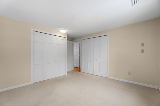 unfurnished bedroom with light colored carpet