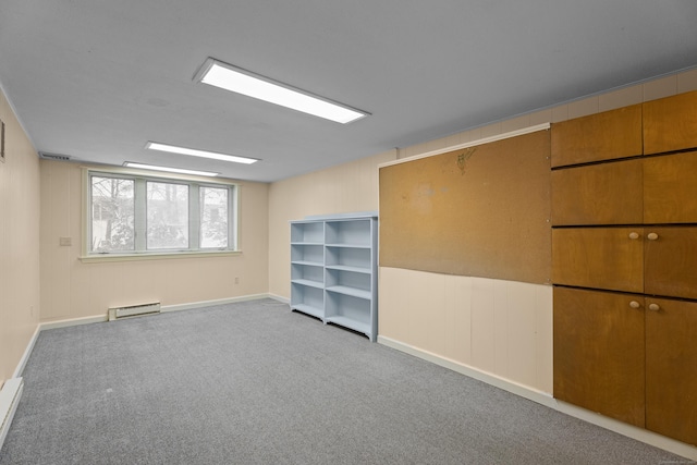 unfurnished room featuring light colored carpet and baseboard heating