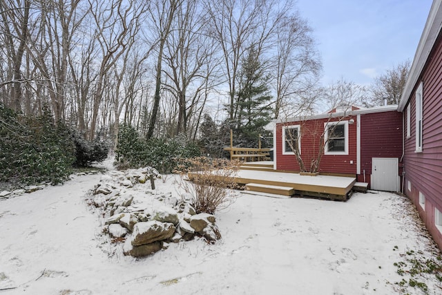 yard layered in snow with a wooden deck