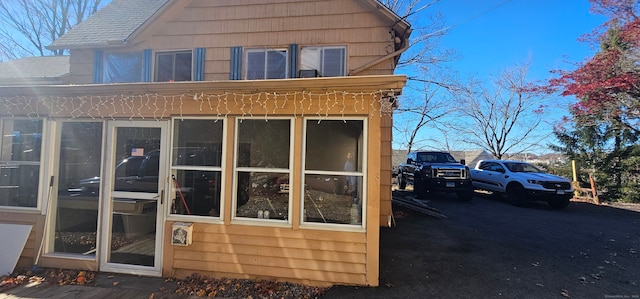 view of side of home featuring a sunroom