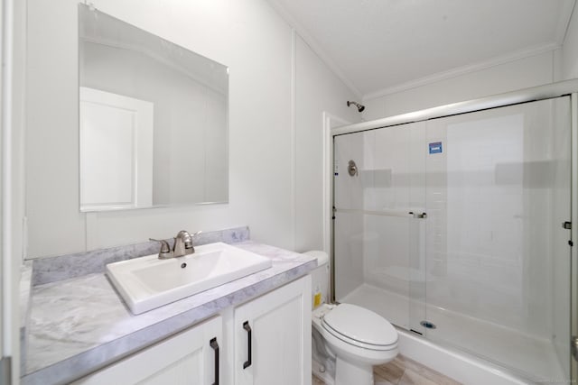 bathroom with vanity, a shower with door, lofted ceiling, toilet, and ornamental molding