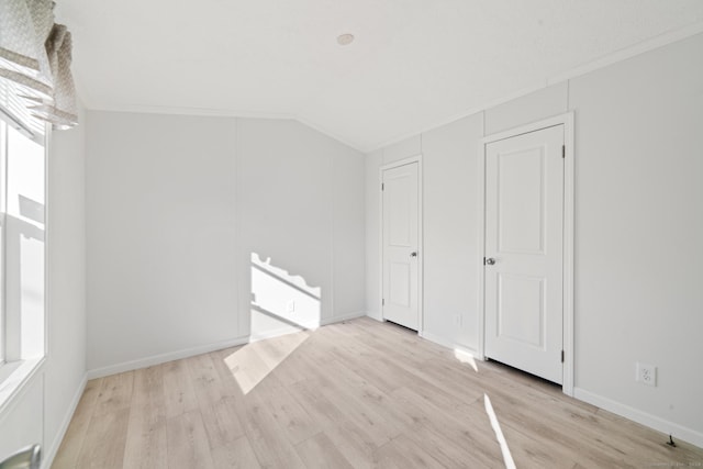 additional living space featuring light hardwood / wood-style floors and lofted ceiling