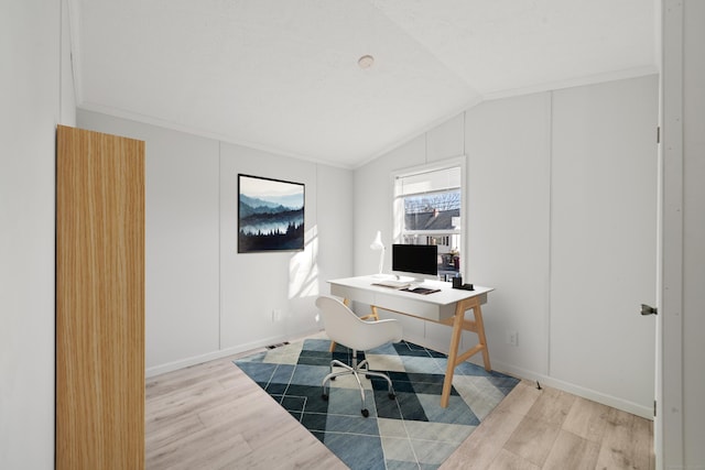 office area with light wood-type flooring and lofted ceiling