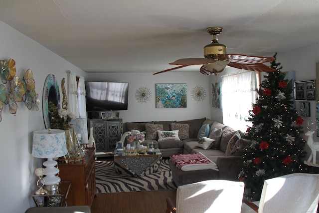 living room with wood-type flooring and ceiling fan