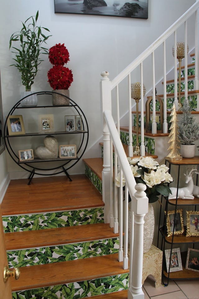 stairs featuring wood-type flooring