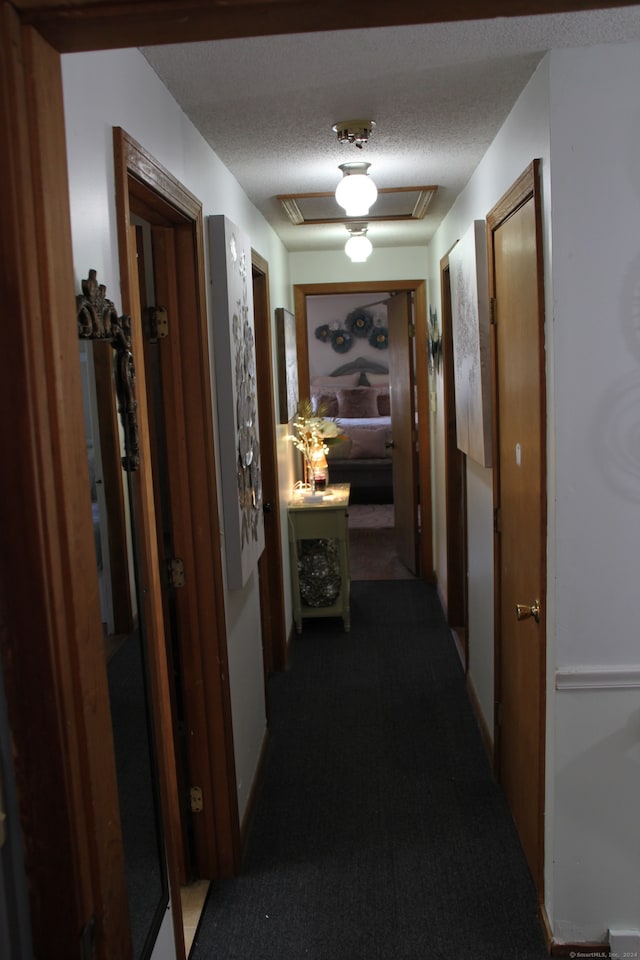 hallway with a textured ceiling