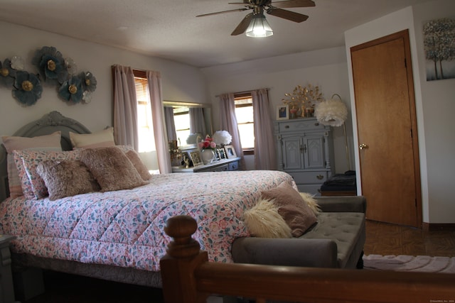 bedroom featuring ceiling fan and parquet floors