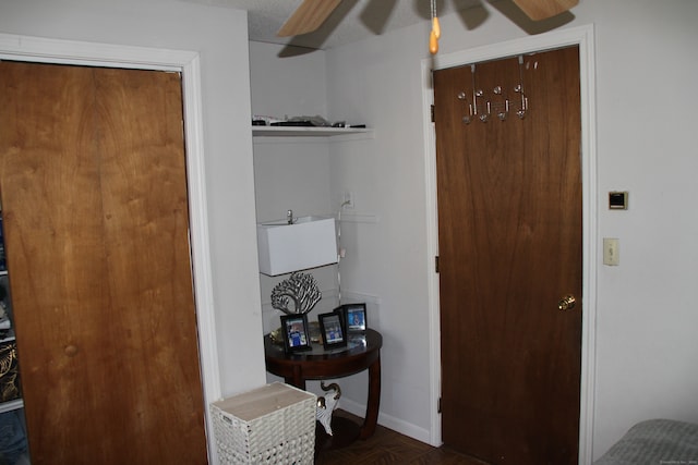 interior space featuring ceiling fan and dark parquet floors