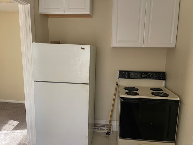 kitchen with white cabinets, light colored carpet, and white appliances