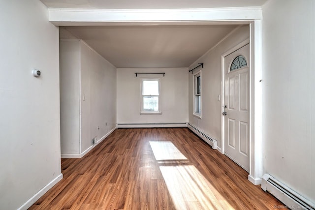 foyer featuring a baseboard radiator and hardwood / wood-style floors