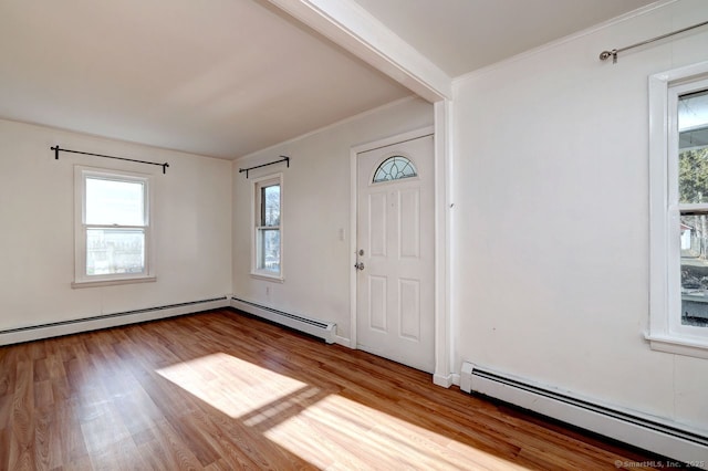 foyer with light hardwood / wood-style flooring, crown molding, and a baseboard radiator